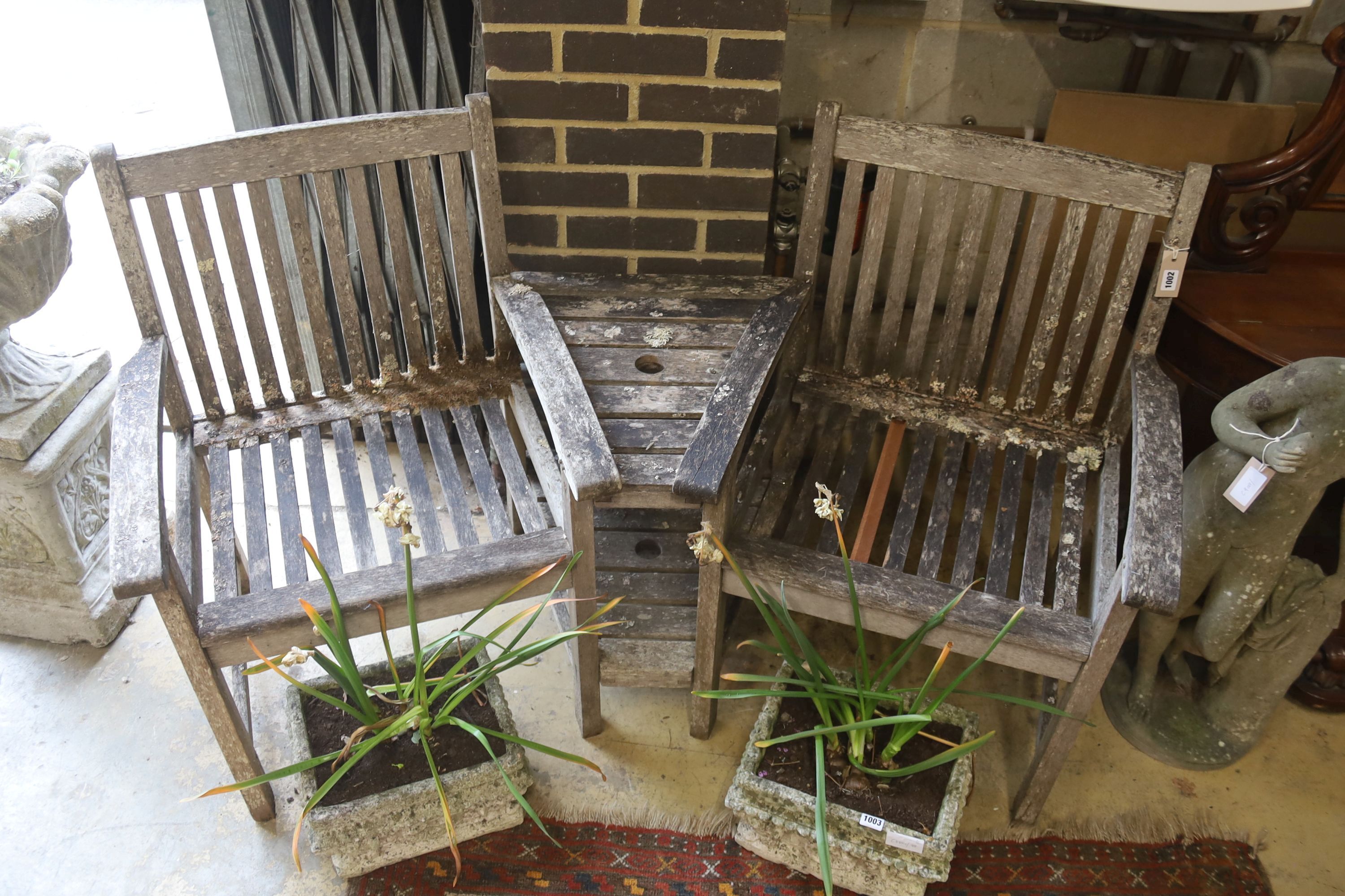 A weathered teak garden love seat, length 155cm, depth 70cm, height 88cm